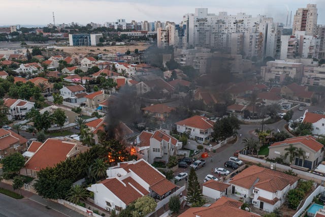 b4683f74aef54a5d97747e727c57e07a-1 Smoke rises after a rocket fired from the Gaza Strip hit a house in Ashkelon, southern Israel
