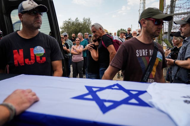 Mourners gather around the coffin of Yosef Vahav, 65, during his funeral in Beit Guvrin, Israel