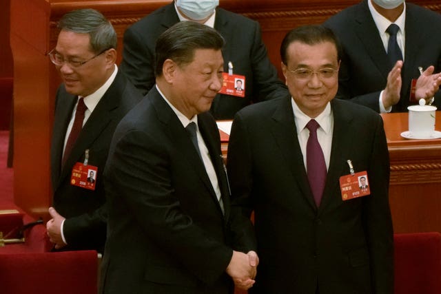 dd06c37df7654579b5ed1c3fe05868bf Newly elected Chinese premier Li Qiang, left, walks past as Chinese President Xi Jinping, centre, shakes hands with former premier Li Keqiang during a session of China’s National People’s Congress (NPC) at the Great Hall of the People in Beijing on March 11 2023