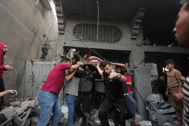 43bdf9d619c141c08d322972cd2c01bb Palestinians evacuate an injured woman found under the rubble of a destroyed house following an Israeli airstrike in Khan Younis refugee camp, southern Gaza Strip, on Saturday