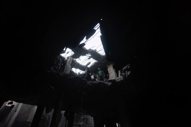 4afdb0ce771742d6b7cb7a18a0e28d3e-1 Palestinians look for survivors inside the remains of a destroyed building following an Israeli airstrike in Khan Younis refugee camp, southern Gaza Strip, on Saturday