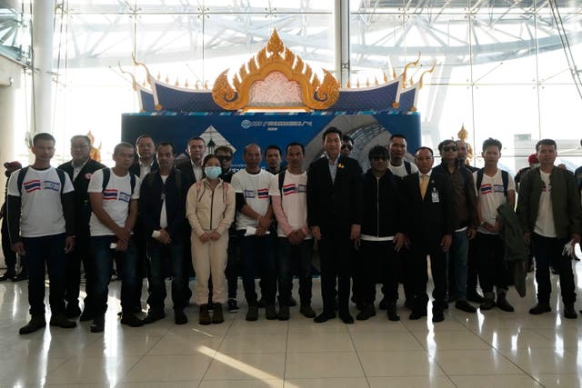 Thailand’s foreign minister Parnpree Bahiddha-Nukara, seventh from left, poses with freed hostages