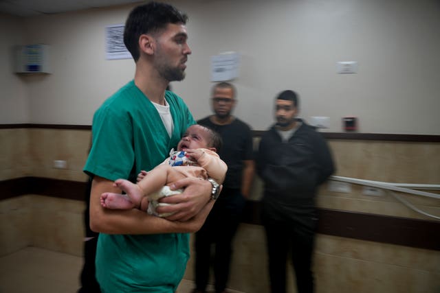 55695f78ed9b40cebbb5ade681a626e5 A Palestinian baby wounded in the Israeli bombardment of the Gaza Strip is brought to a hospital in Deir al-Balah