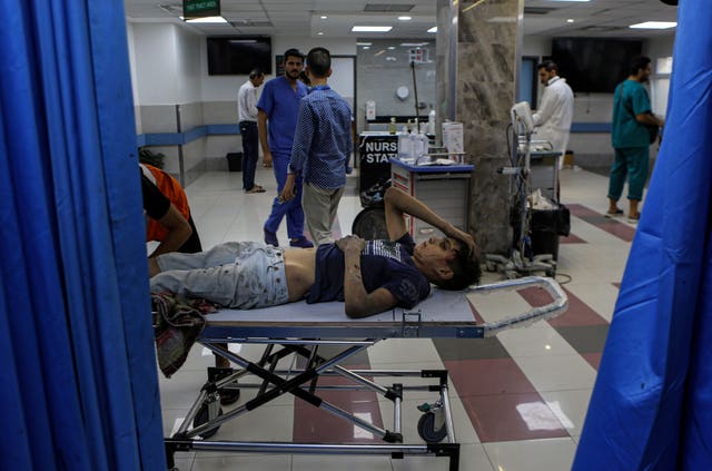 5b87e5b0da0442f5999d442c27701010 A wounded Palestinian boy arrives in the emergency room of the al-Shifa hospital following Israeli air strikes on Gaza City, central Gaza Strip
