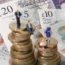 Models of men and women on top of coins and notes