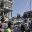 Palestinians look for survivors of the Israeli bombardment in the Maghazi refugee camp