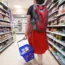A shopper walking through the aisle of a supermarket