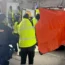 Paramedics cover the view of an ambulance at the scene of the shooting in Madrid