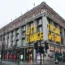People walk past Selfridges department store on Oxford Street in London