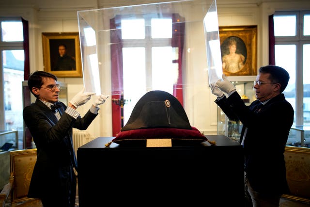 7c502517c7724dada9a1aa83f594f861 Raphael Pitchal, left, and Jean Christophe Chataignier of Osenat’s auction house remove the protection of one of the signature broad, black hats that Napoleon wore when he ruled 19th-century France and waged war in Europe at Osenat’s auction house in Fontainebleau, south of Paris