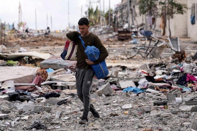 9555d54113f64b49b0ddfd18e6de9199 A Palestinian man collects his belongings south-east of the Gaza City
