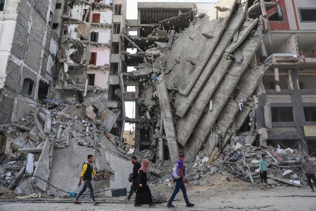 Palestinians walk through Gaza City