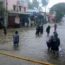 People wade through a flooded street in Chennai