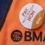 A BMA jacket with a badge saying 'pay restoration now'