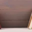 Bookshelf with books on wooden plank wall