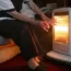 An elderly lady with her electric fire on