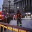 New York firefighters walk up to the entrance of New York Supreme Court