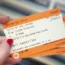 A person holding train tickets