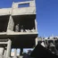 Palestinians look at the destruction after an Israeli strike on residential buildings in Rafah, Gaza Strip, on Friday