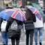 Rain falling on people under umbrellas