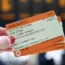 A person holding train tickets