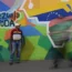 A man sells phone cables in front of a mural of the Venezuelan map with the Essequibo territory included