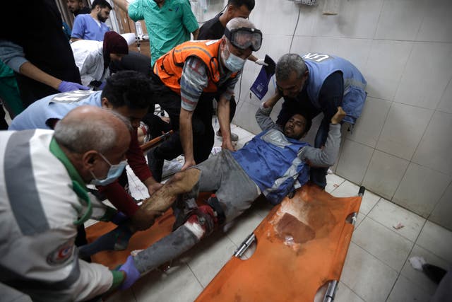 d84ea30e55884695bb6e3edff3de4e73 A United Nations worker wounded in Israeli airstrikes on a UN-run school arrives at the Nasser hospital in the town of Khan Younis, southern Gaza Strip, on Sunday