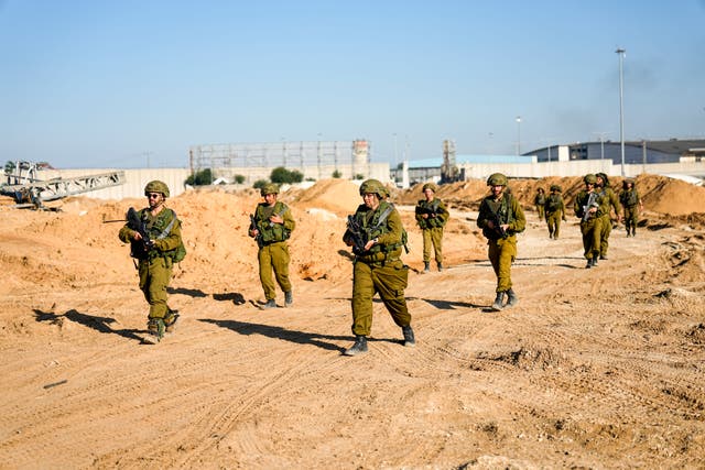e490cd4a09e5416d8161ade3cb22f1f4 Israeli soldiers are seen during a ground operation in the northern Gaza Strip on Friday