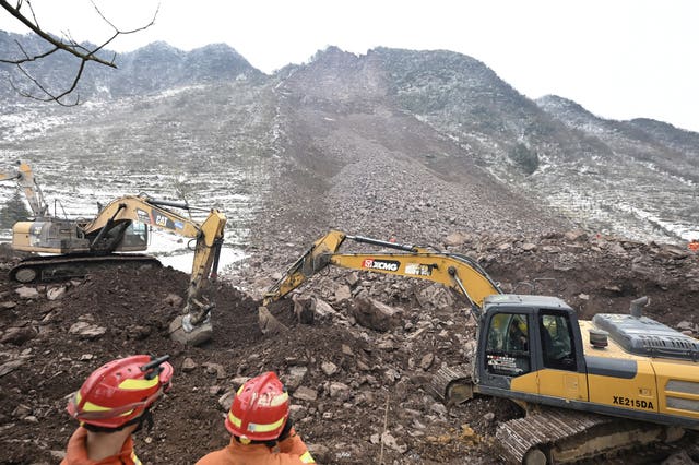 A bulldozer clears rubble
