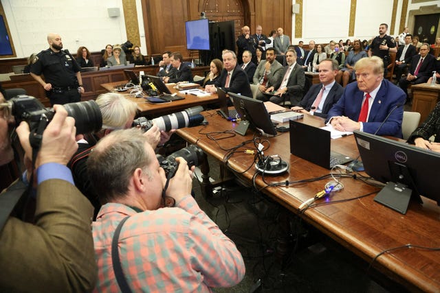 Former US president Donald Trump, right, sits in the courtroom before the start of closing arguments in his civil business fraud trial at New York Supreme Court