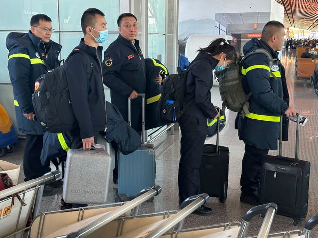 59af5087a13742fd84d8c03015874778 Rescue workers prepare to board a flight to Xinjiang from Beijing Capital International Airport in Beijing on Tuesday