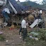 A man looks at homes destroyed after air and artillery strikes in Mung Lai Hkyet displacement camp, in Laiza, Myanmar, in October