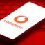 The logo of mobile phone network Vodafone is displayed on the screen of a smartphone