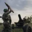 A Ukrainian soldier fires a mortar towards Russian positions at the front line, near Bakhmut