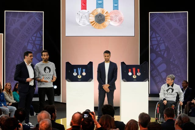23c4071c8beb4b159f1e22e58b6dbbe7 Tony Estanguet, centre, president of the Paris Organising Committee of the 2024 Olympic and Paralympic Games, stands by the medals for the Paris 2024 Olympics, left, and Paralympics, at the Paris Olympic organisers in Saint-Denis, outside Paris