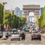 The Champs-Elysees in Paris with the Arc de Trimophe in the background, with a foreground of car traffic. To be renewed for the 2024 Olympics.