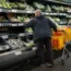 Shoppers in the fruit and vegetables section of a supermarket