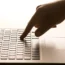 A hand on a laptop