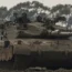 Israeli soldiers drive a tank near the Gaza Strip border, in southern Israel (Tsafrir Abayov/AP)