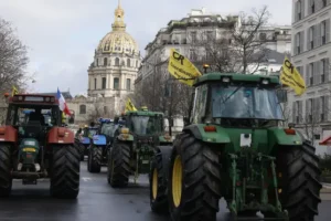 French farmers take tractors back on the streets of Paris in new protest