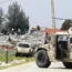 A Lebanese army vehicle blocks a road leading to a warehouse which was destroyed by Israeli air strikes