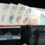 A wallet containing cash and cards