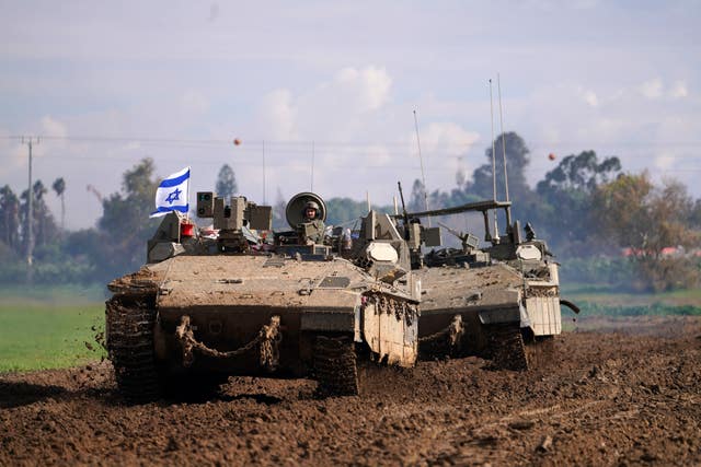 a6c6f475b27946f58e1705117a217a93-1 Israeli soldiers drive in their armoured vehicles in southern Israel near the border with the Gaza Strip during ongoing ground operations