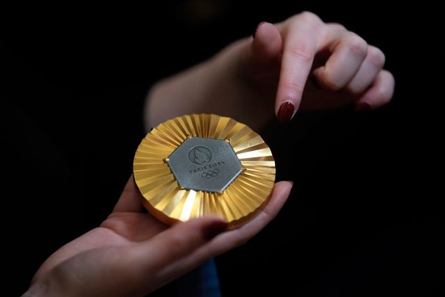 de320019e9614474ada98da6df918837 The Paris 2024 Olympic gold medal is presented to the press in Paris