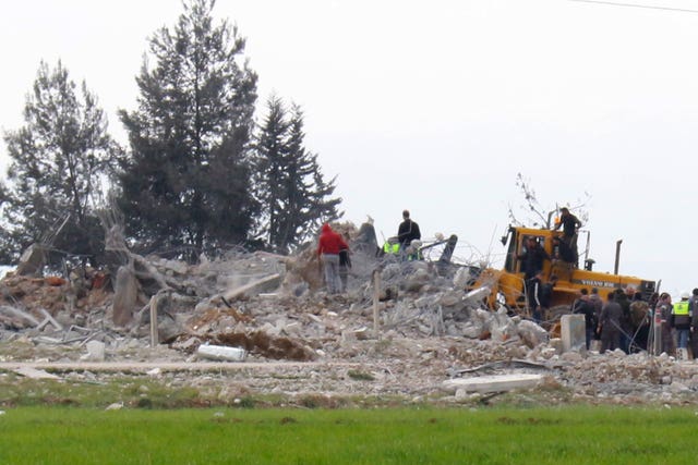 edd32cbe59964f519bac1481905c0508 Civil defence workers at the site of a destroyed warehouse in Lebanon