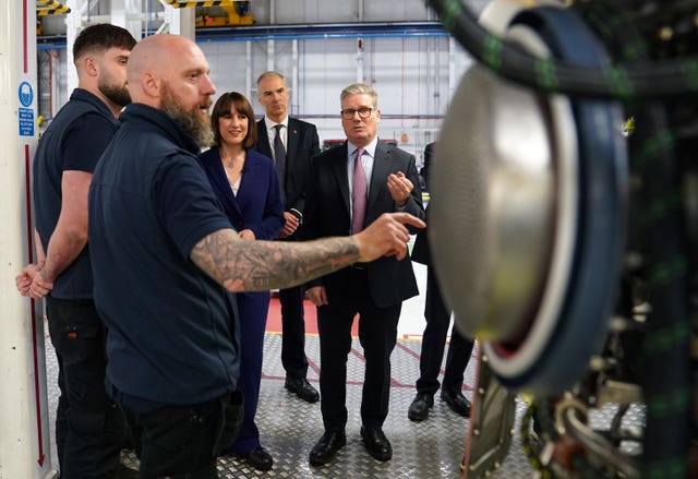 2-76355325 Labour leader Sir Keir Starmer (right) talking to members of staff during a visit to Rolls-Royce in Derby
