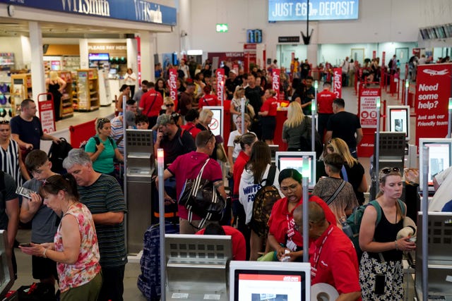 2-76889180-2 Passengers queue at Birmingham Airport
