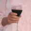 A person holding a glass of wine