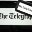 The logo of The Telegraph newspaper displayed on the screens of a tablet and a smartphone