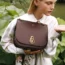 A model holds a Mulberry handbag